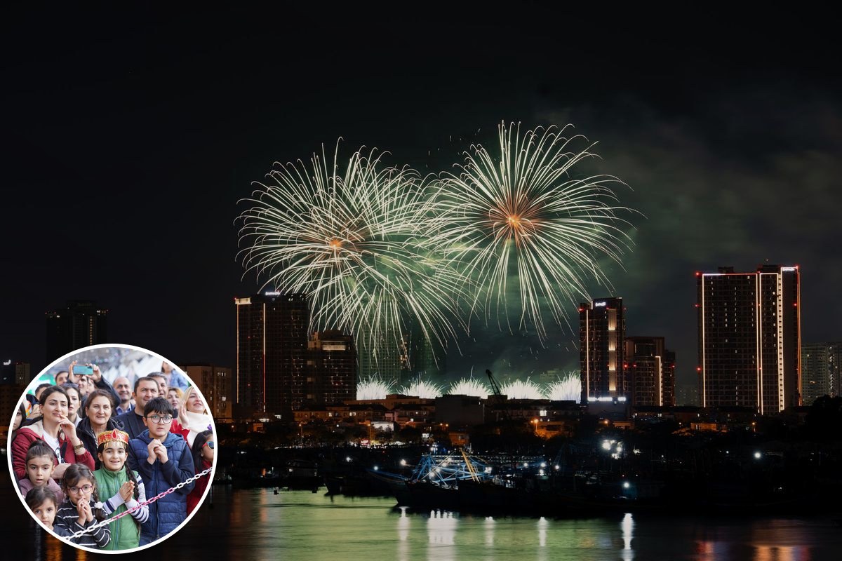 Fireworks bursting over a city skyline at night.