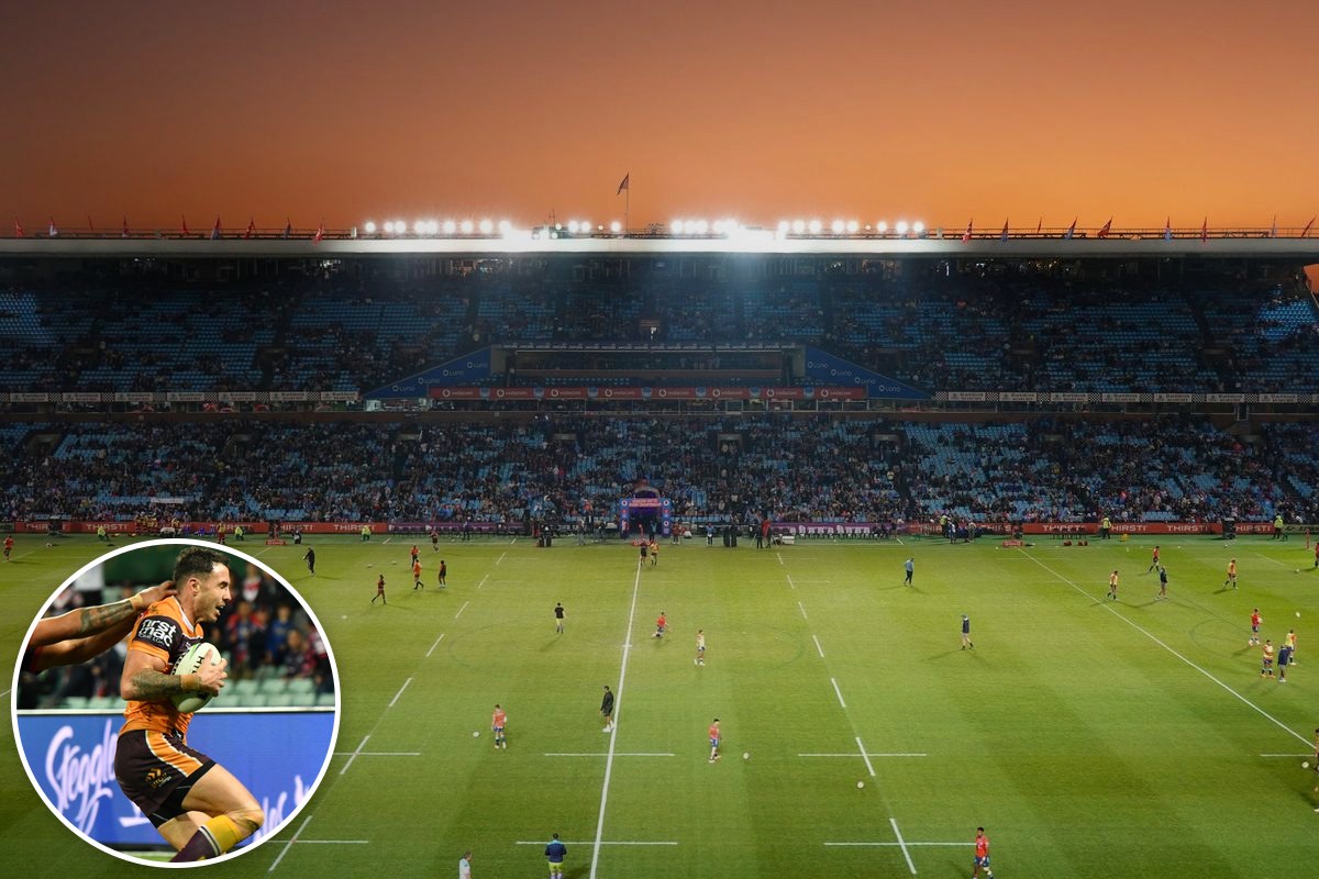 A crowd fills a stadium under lights at dusk, with an inset photo of Darius Boyd carrying the ball for the Broncos.